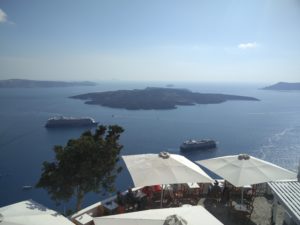 View from Fira with the volcanic island of Nea Kameni at the centre.